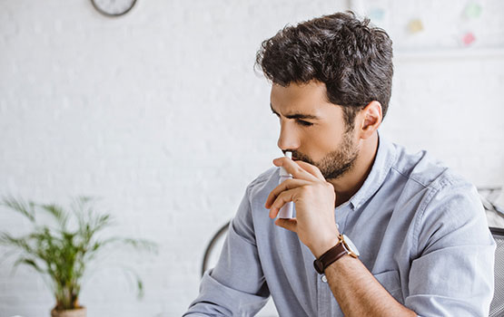 Man Using Nasal Spray